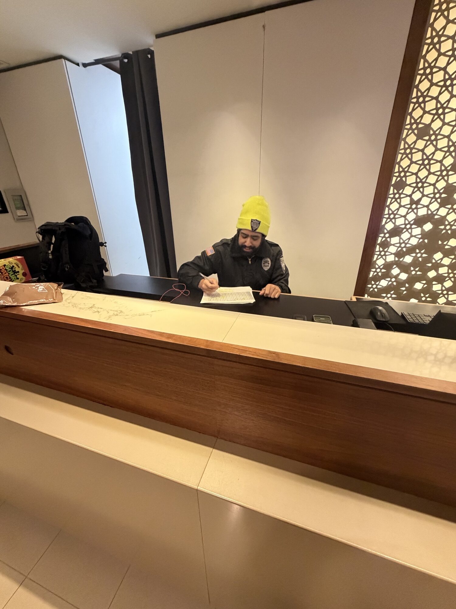 Hotel security guard completing GPS-verified patrol checkpoint in Providence hotel corridor