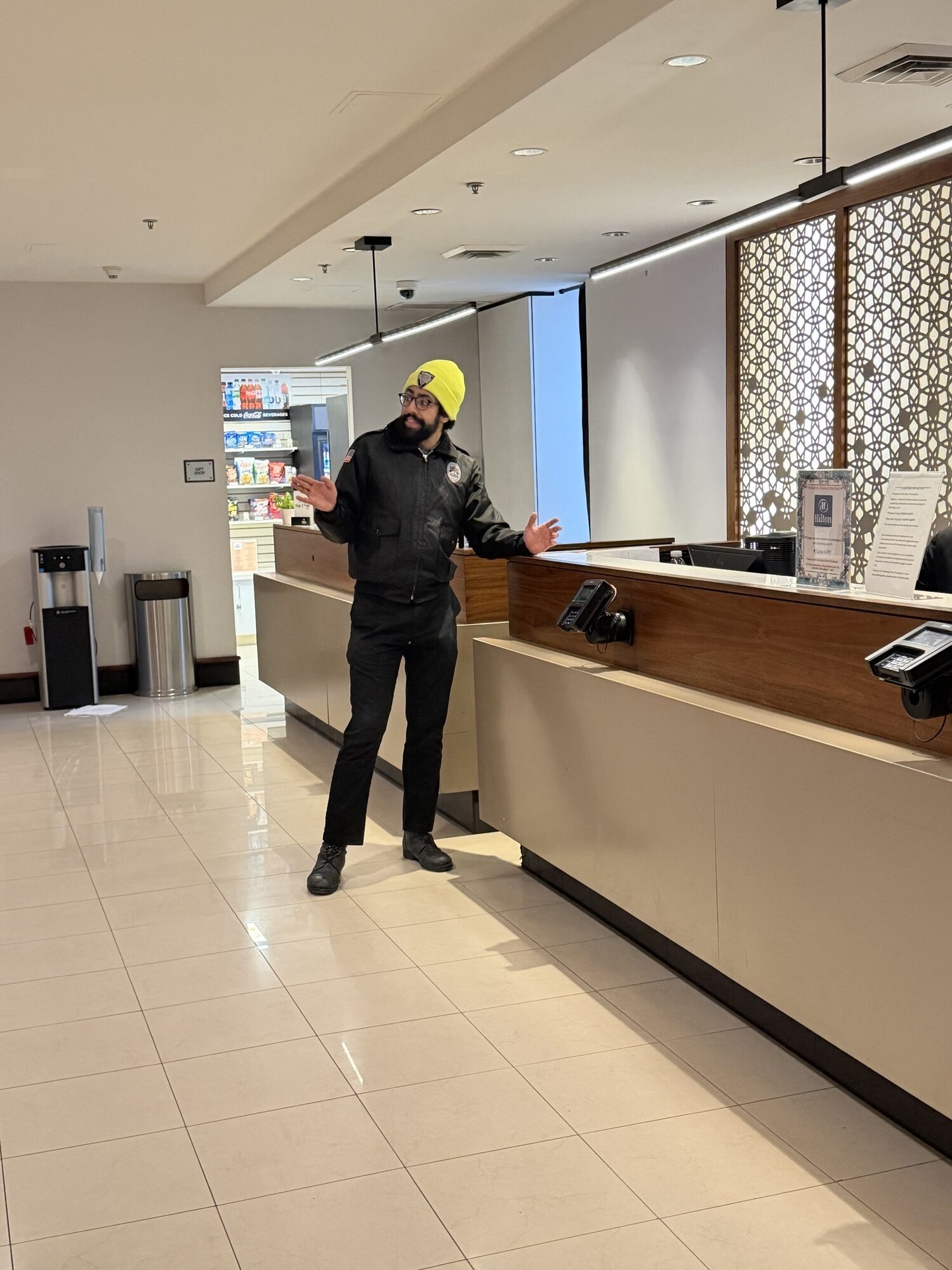 Professional security guard providing hospitality-focused protection at hotel lobby in Providence RI