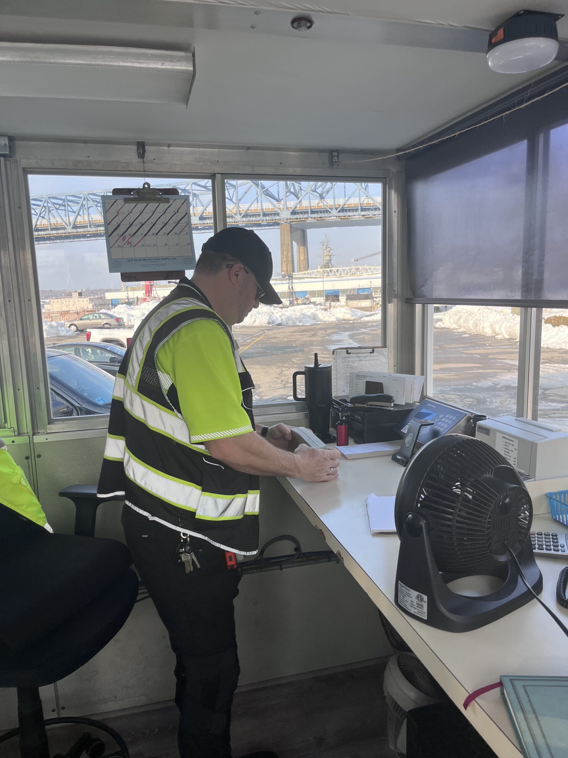 Professional security officer monitoring industrial property in Fall River MA with AI camera systems