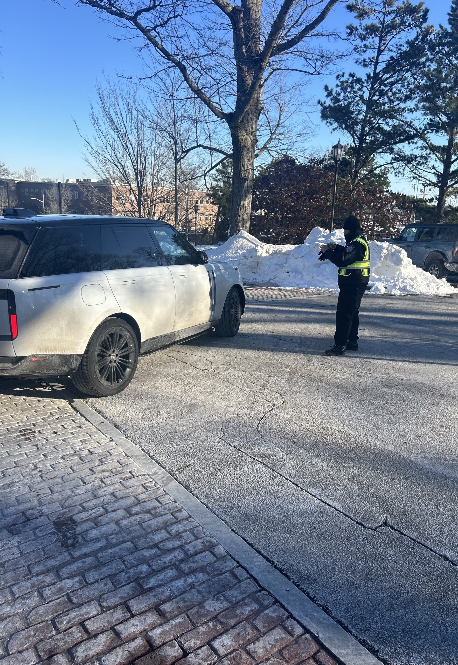 Education-trained security guard monitoring school campus during student arrival in Rhode Island