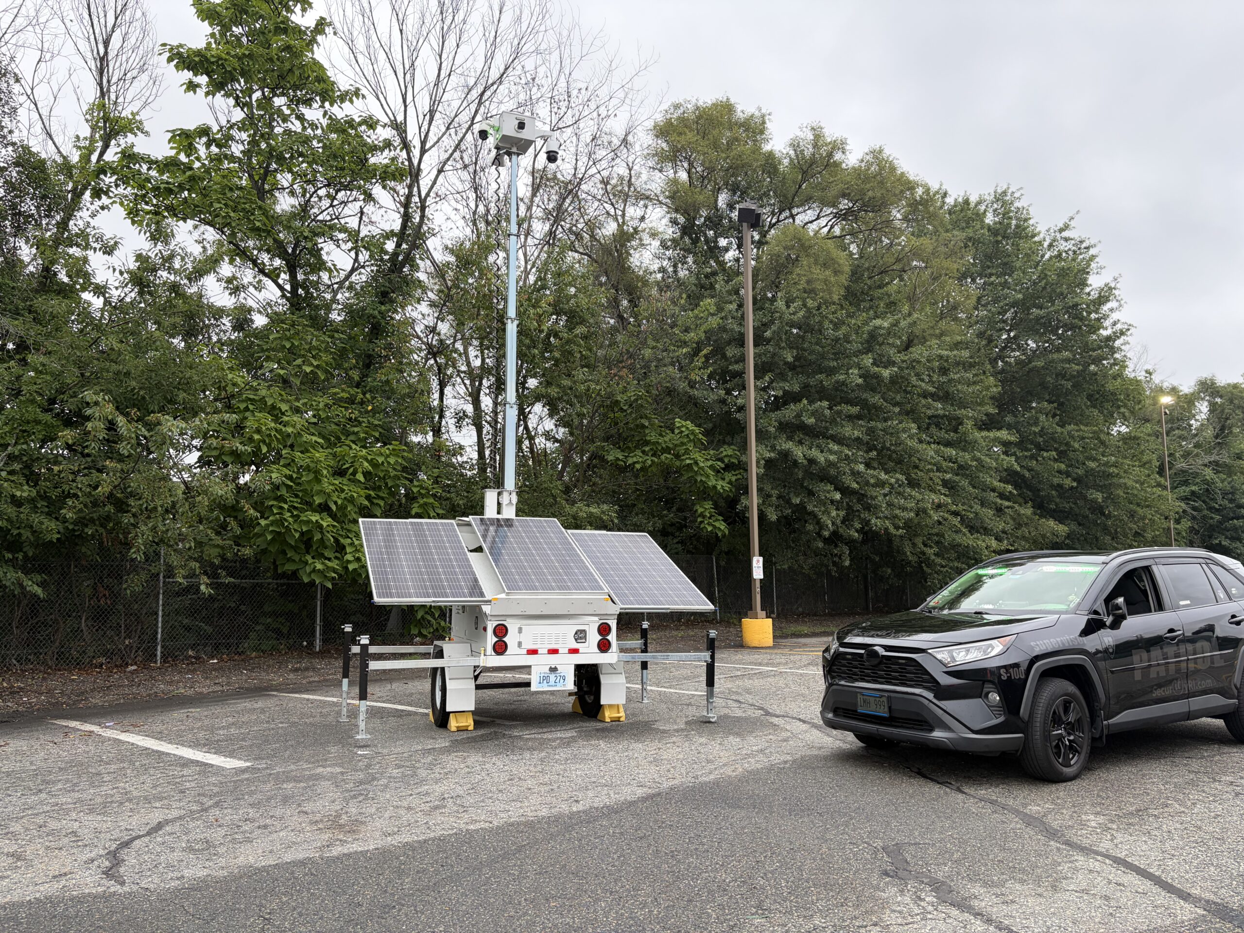 SecurityRI solar-powered mobile security trailer deployed at a Rhode Island retail parking lot capturing AI surveillance footage